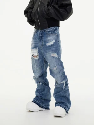 Men's distressed light blue baggy jeans three quarter front view showing relaxed wide leg fit and thigh rips