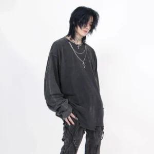 Front three-quarter view of men's distressed oversized long-sleeve tee with dropped shoulders and cross necklace