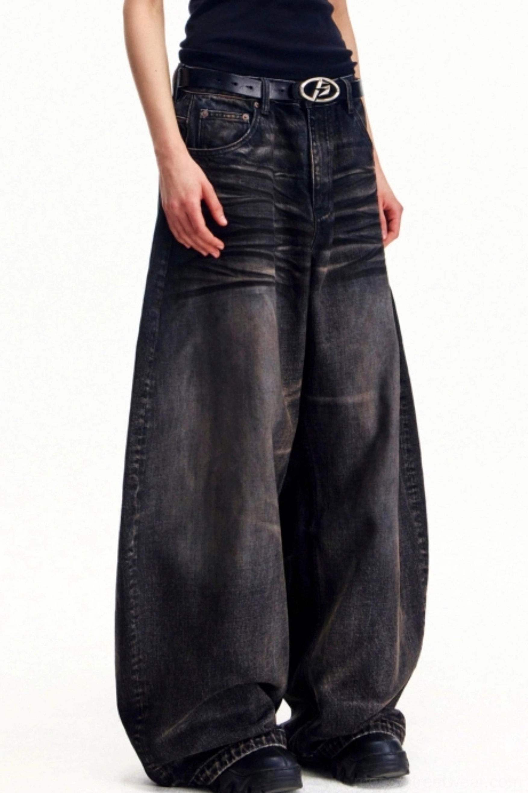 Men's distressed vintage washed wide leg jeans side view showing oversized draped denim silhouette