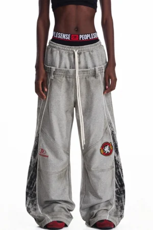 Front side view of black and gray men's double-waisted baggy sweatpants with ink-washed side panels and reflective-style streetwear detailing