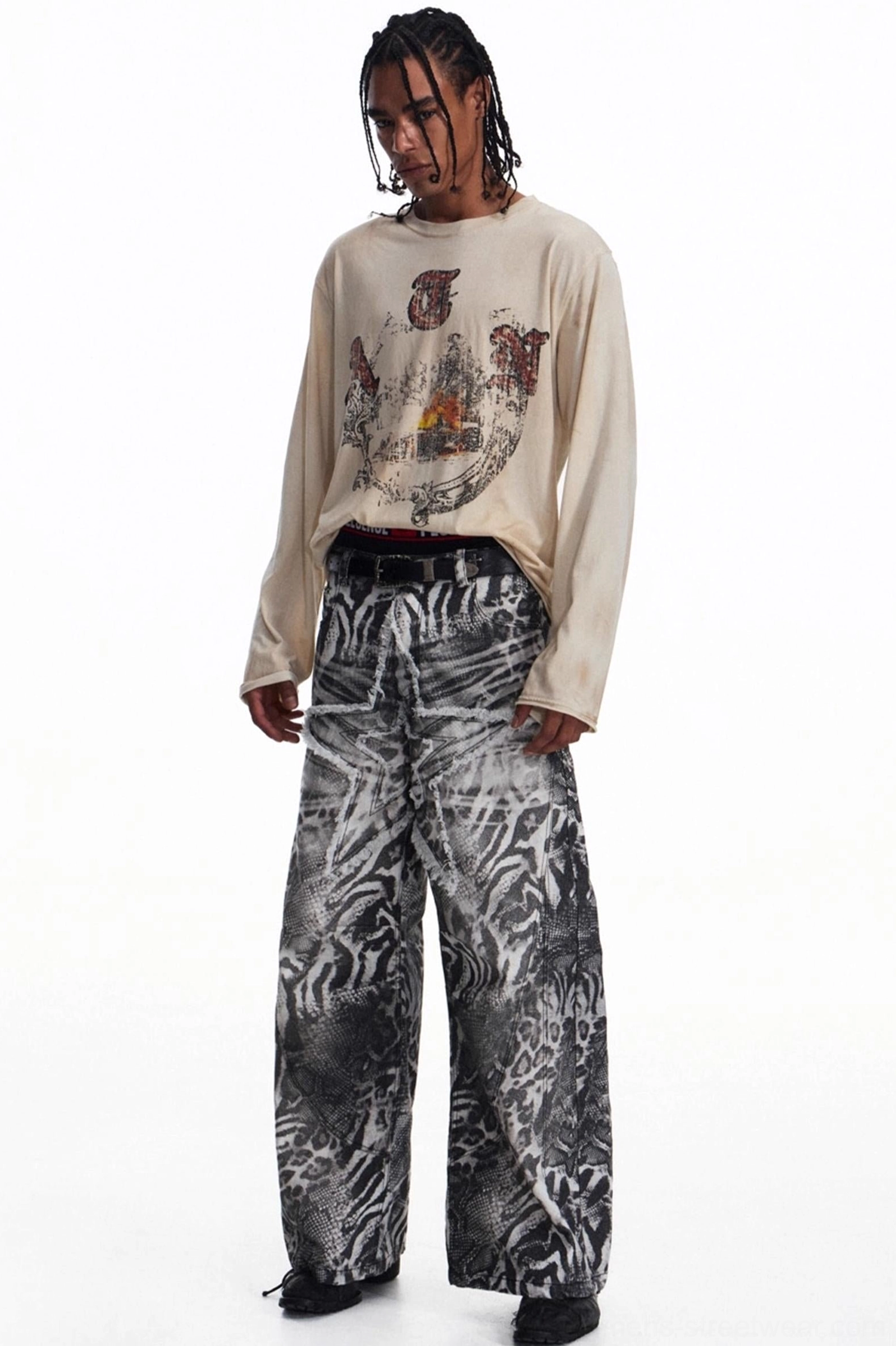 Three-quarter back view of men's faded apricot graphic t-shirt styled with wide-leg trousers for East Asian streetwear