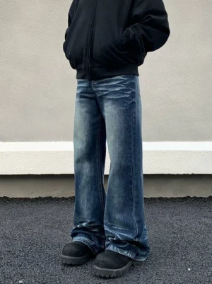Front view of relaxed men's wide flare jeans in faded blue cotton denim with classic pockets, whiskered thighs, stacked trouser hems, and casual Seoul streetwear outfit