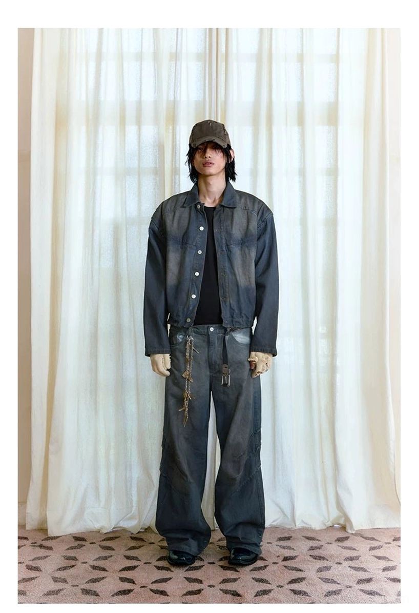Full body men's matching faded indigo denim outfit featuring panel trucker jacket, wide-leg jeans, cap and waist chain