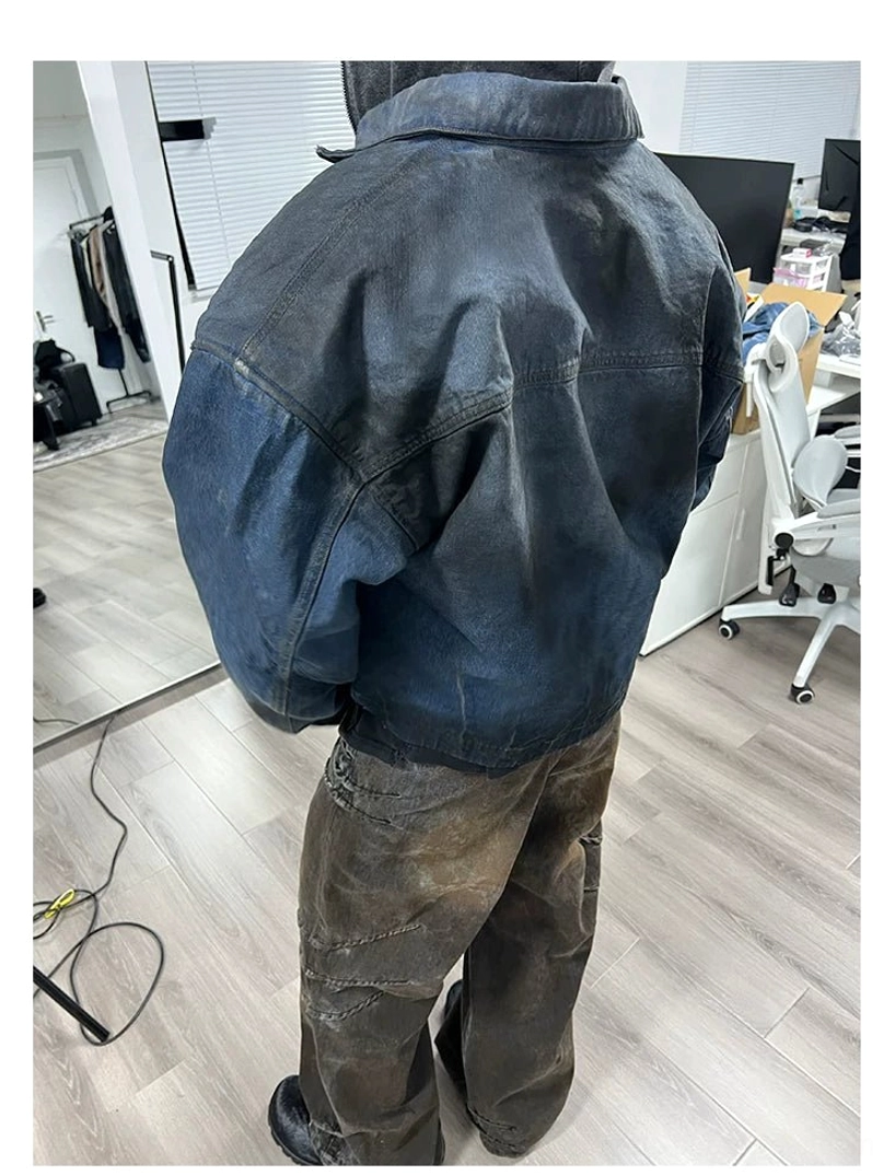 Rear three-quarter outfit view of faded indigo panel denim trucker jacket and distressed washed denim pants streetwear set