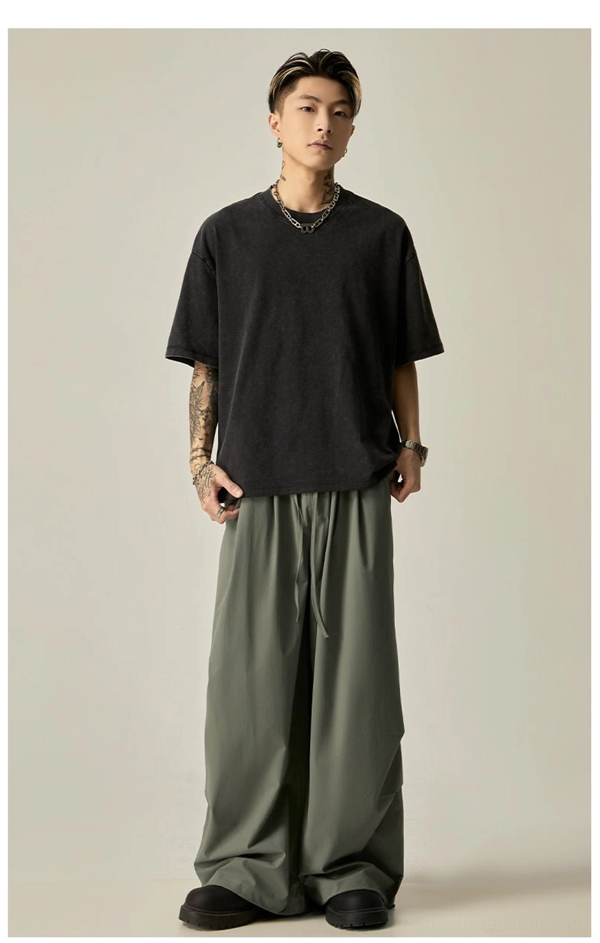 Men's flowy wide leg drawstring pants in sage green and black for Korean-inspired streetwear outfits