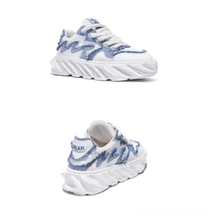 Frayed wave chunky sneakers shown from an angled rear view with distressed textile panels, layered upper, and thick white midsole
