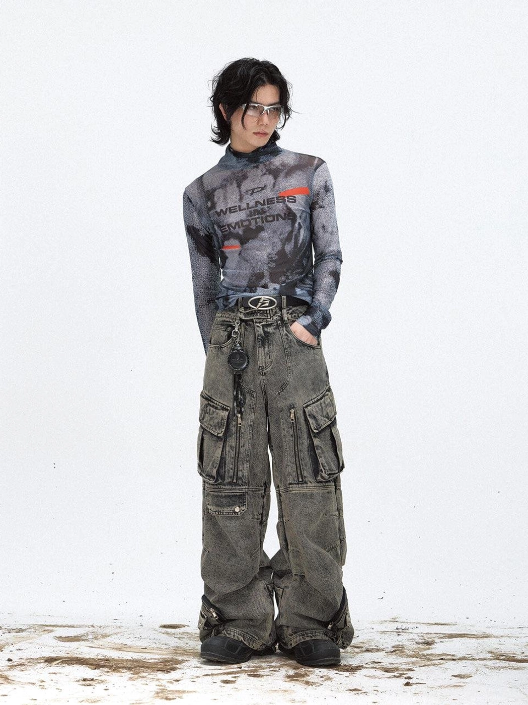 Male model wearing a black futuristic printed mesh turtleneck sweatshirt with gray cargo jeans in a Seoul streetwear style
