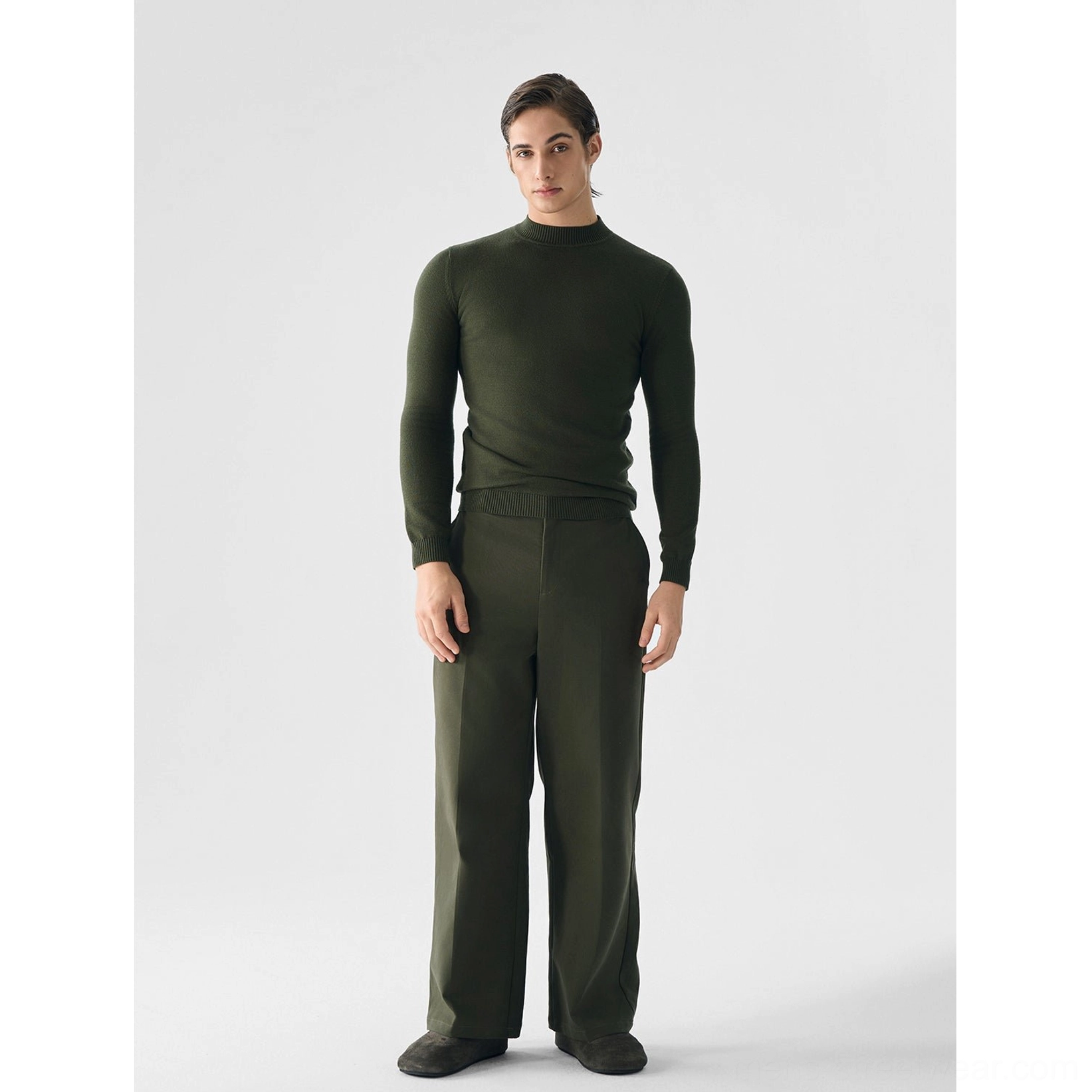Men's green slim fit half high neck knit sweater full body studio view with coordinated wide leg pants