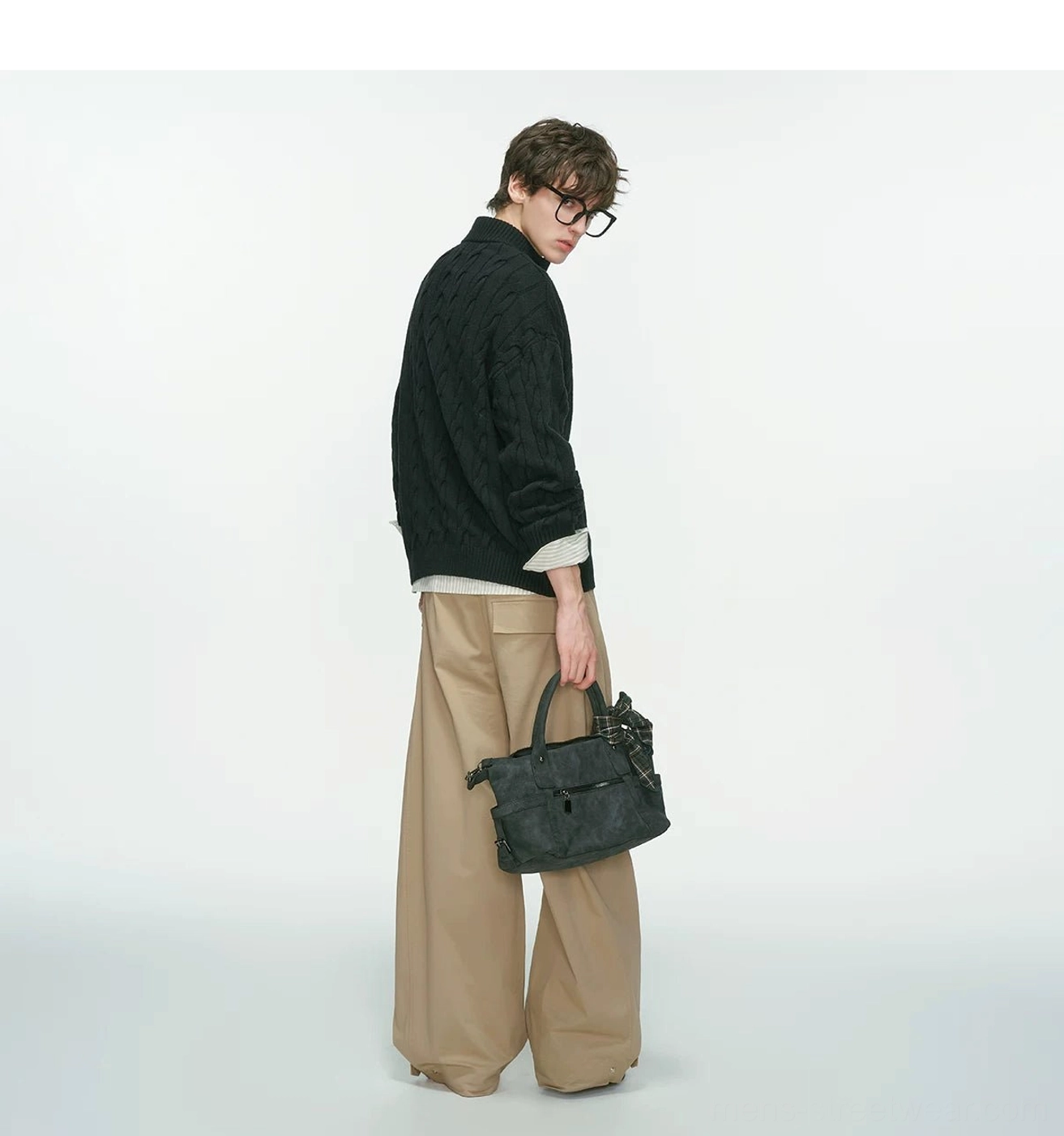 Men’s half-zip cable knit sweater showing textured stitching and easy layered styling