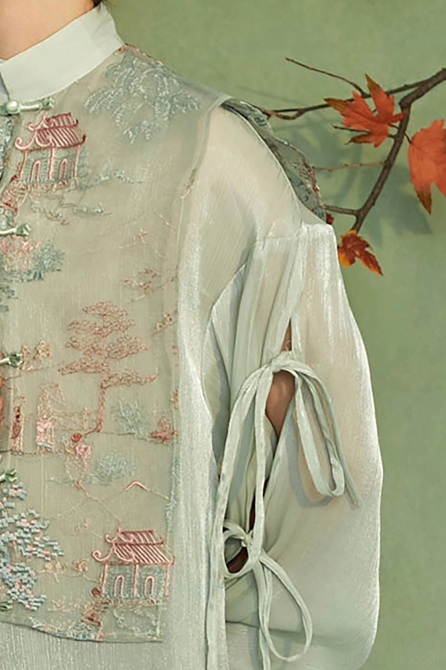 Detailed view of mandarin collar Chinese landscape embroidery and cutout drawstring sleeve on mens Hanfu jacket