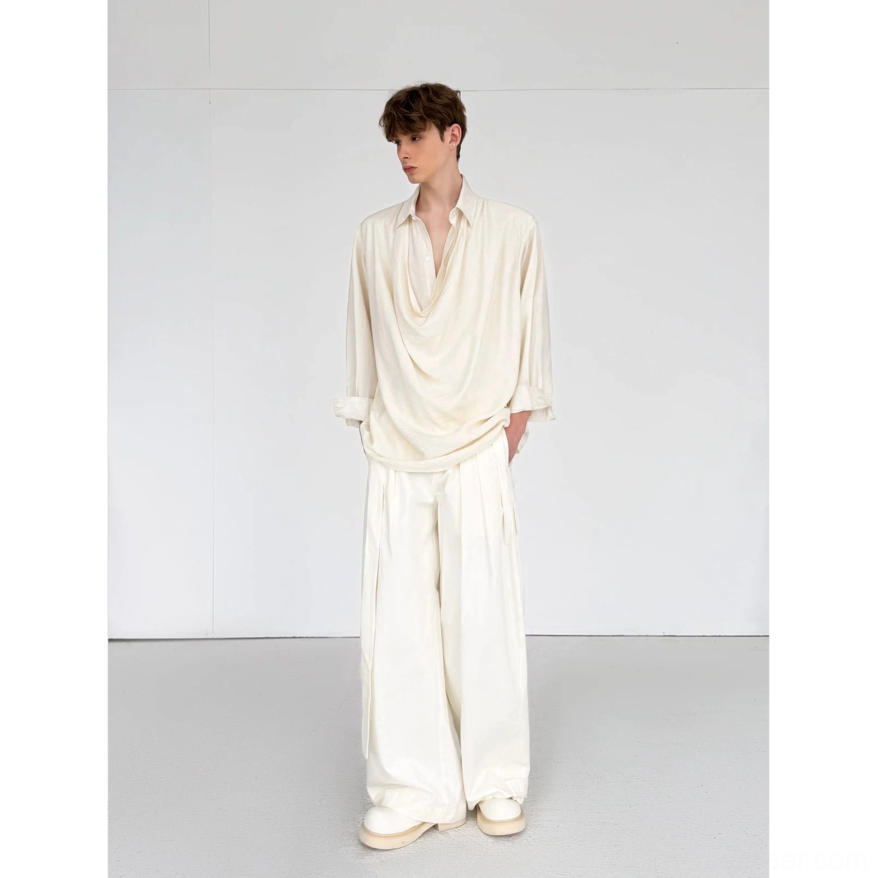 Full-body view of men's ivory draped cowl neck shirt and matching wide-leg pants two-piece streetwear set