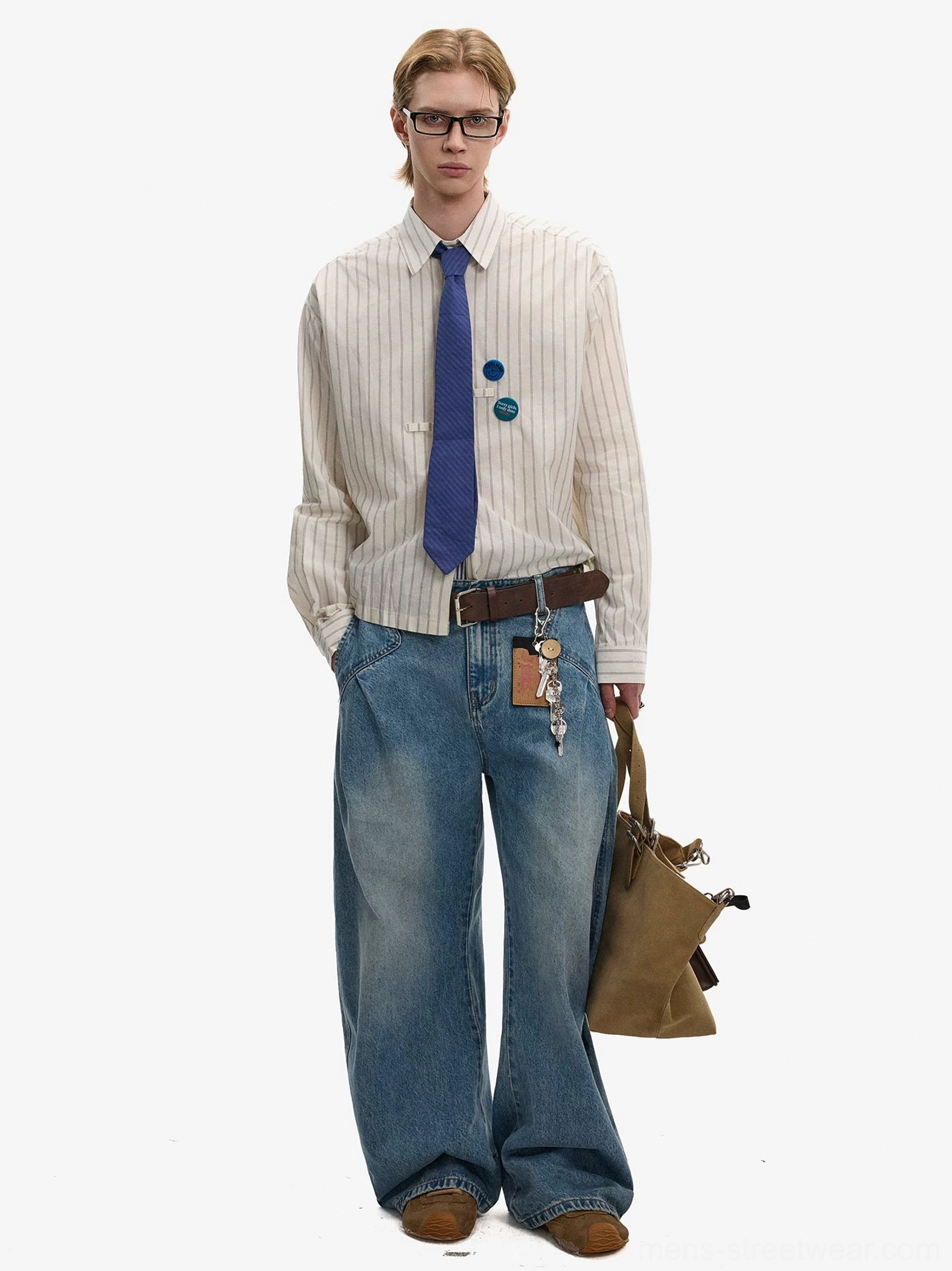 Mens ivory pinstripe Oxford shirt and blue tie styled with denim jeans belt and canvas bag for Korean streetwear look