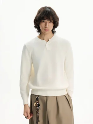 Men's ivory waffle knit Henley sweater styled with khaki trousers showing relaxed regular fit and ribbed hem