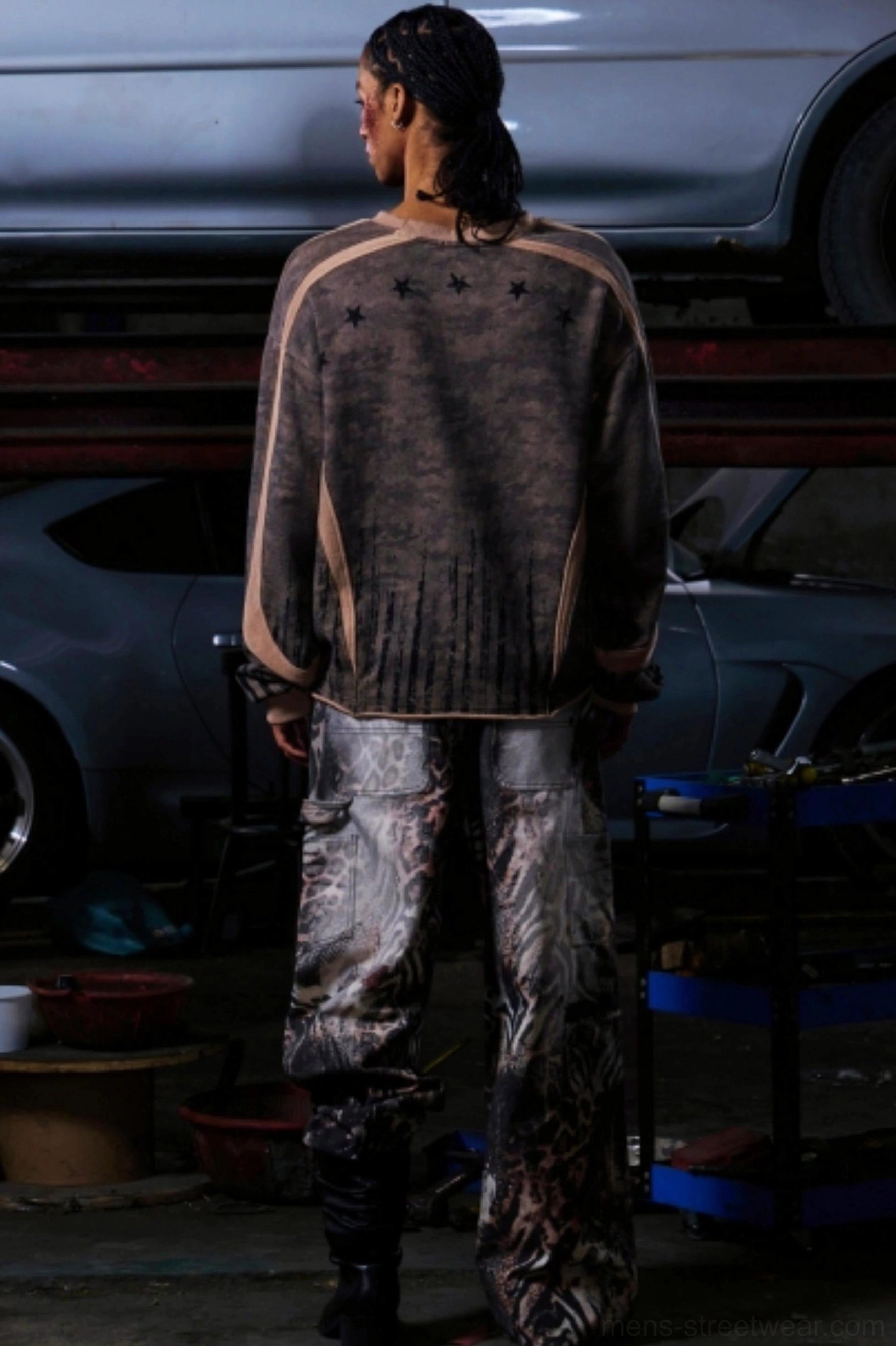Back view of men's khaki camouflage half-zip pullover with visible star-inspired detail and baggy wide-leg styling