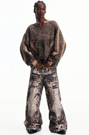 Men's oversized khaki camouflage half-zip pullover shown from the front with relaxed drop shoulders and wide-leg streetwear styling