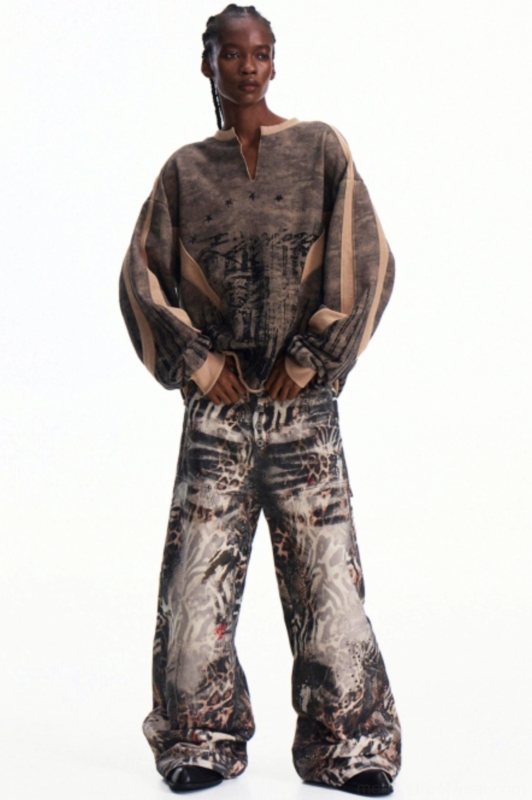 Men's oversized khaki camouflage half-zip pullover shown from the front with relaxed drop shoulders and wide-leg streetwear styling