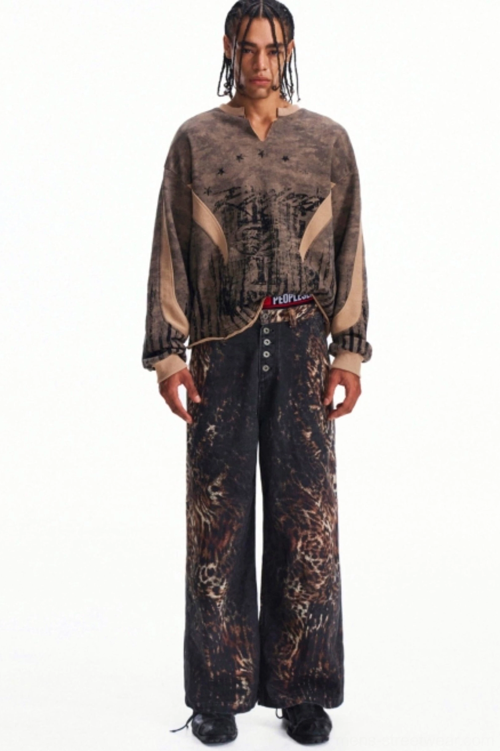 Front view of men's khaki printed half-zip pullover styled with loose animal print wide-leg trousers