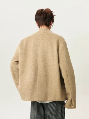 Khaki stand collar wool blend jacket back view showing relaxed dropped shoulders seamless back panel and button cuff details