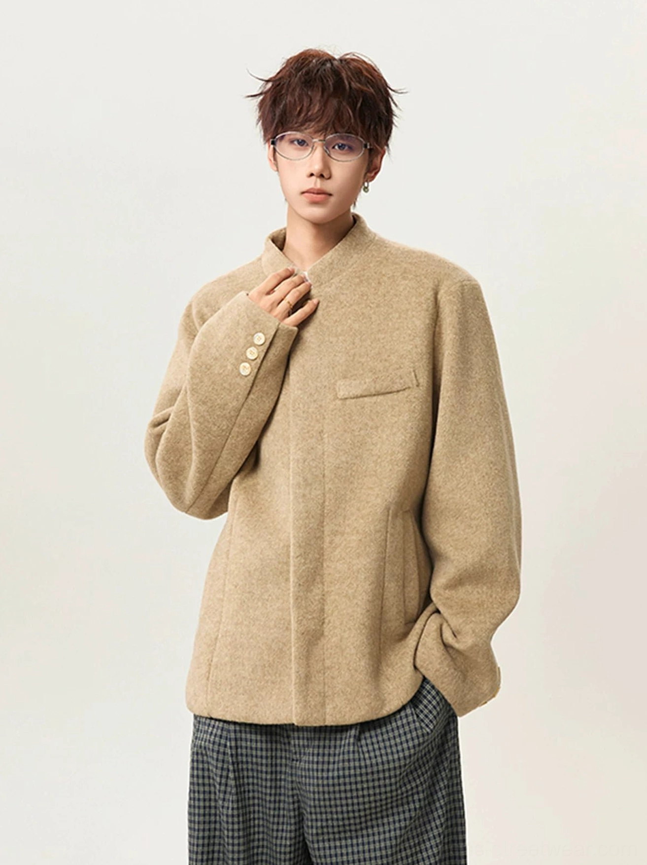 Khaki men's stand collar wool blend jacket front three quarter view with relaxed drop shoulder fit and checkered wide leg trousers