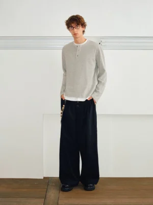 Full-body view of men's long-sleeve layered Henley shirt with slim relaxed fit in a minimalist Korean streetwear outfit
