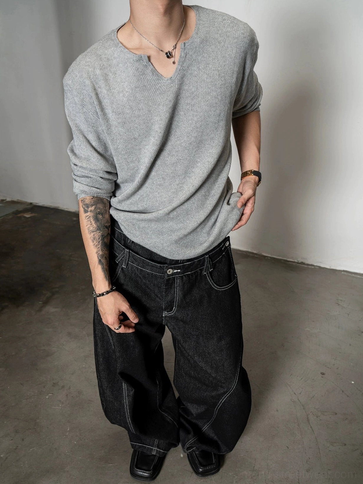 Light gray men's relaxed notch neck knit sweater styled with dark wide leg denim in modern Seoul fashion