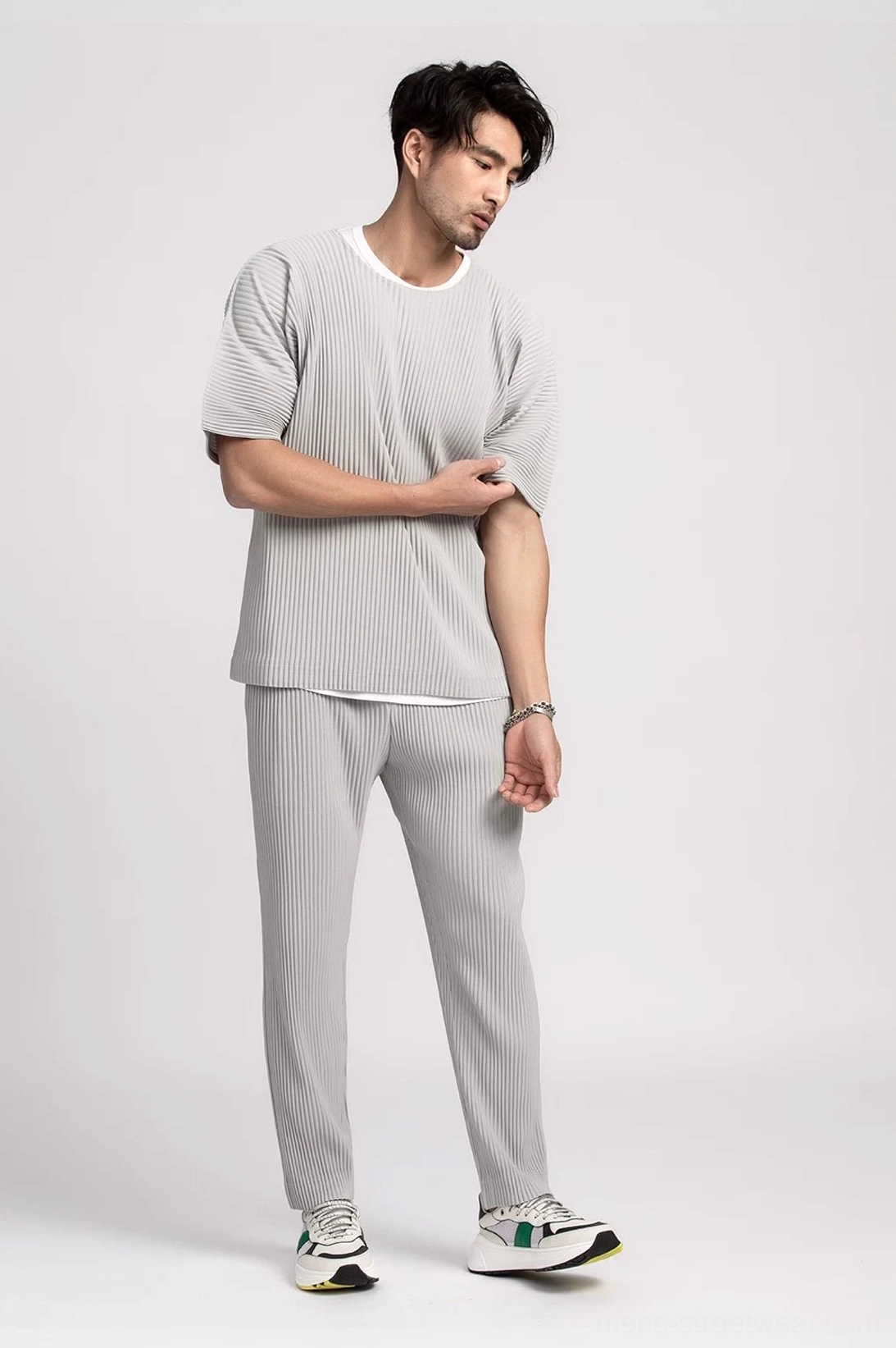 Men's light grey pleated boxy tee and matching trousers styled in a relaxed Korean fashion look