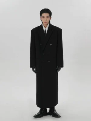 Full front view of men’s long black double-breasted wool overcoat with notch lapels and tailored formal styling