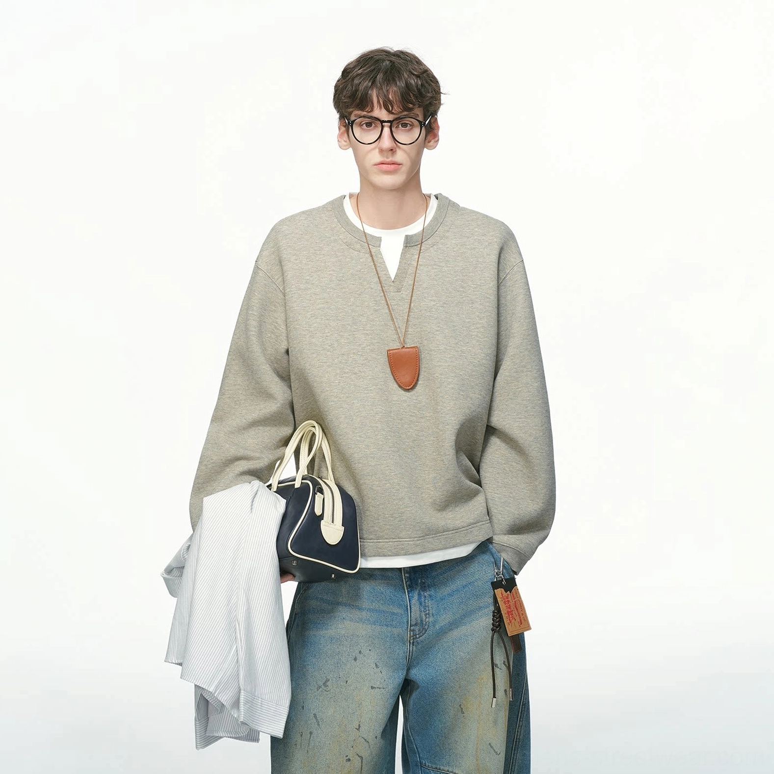 Men's modern streetwear crew sweatshirt with dropped shoulders, roomy sleeves, relaxed drape, and clean layered hem detail