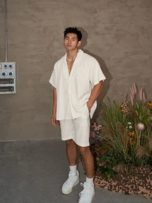 Men's off-white linen-look camp collar shirt and matching shorts set in relaxed Korean streetwear style