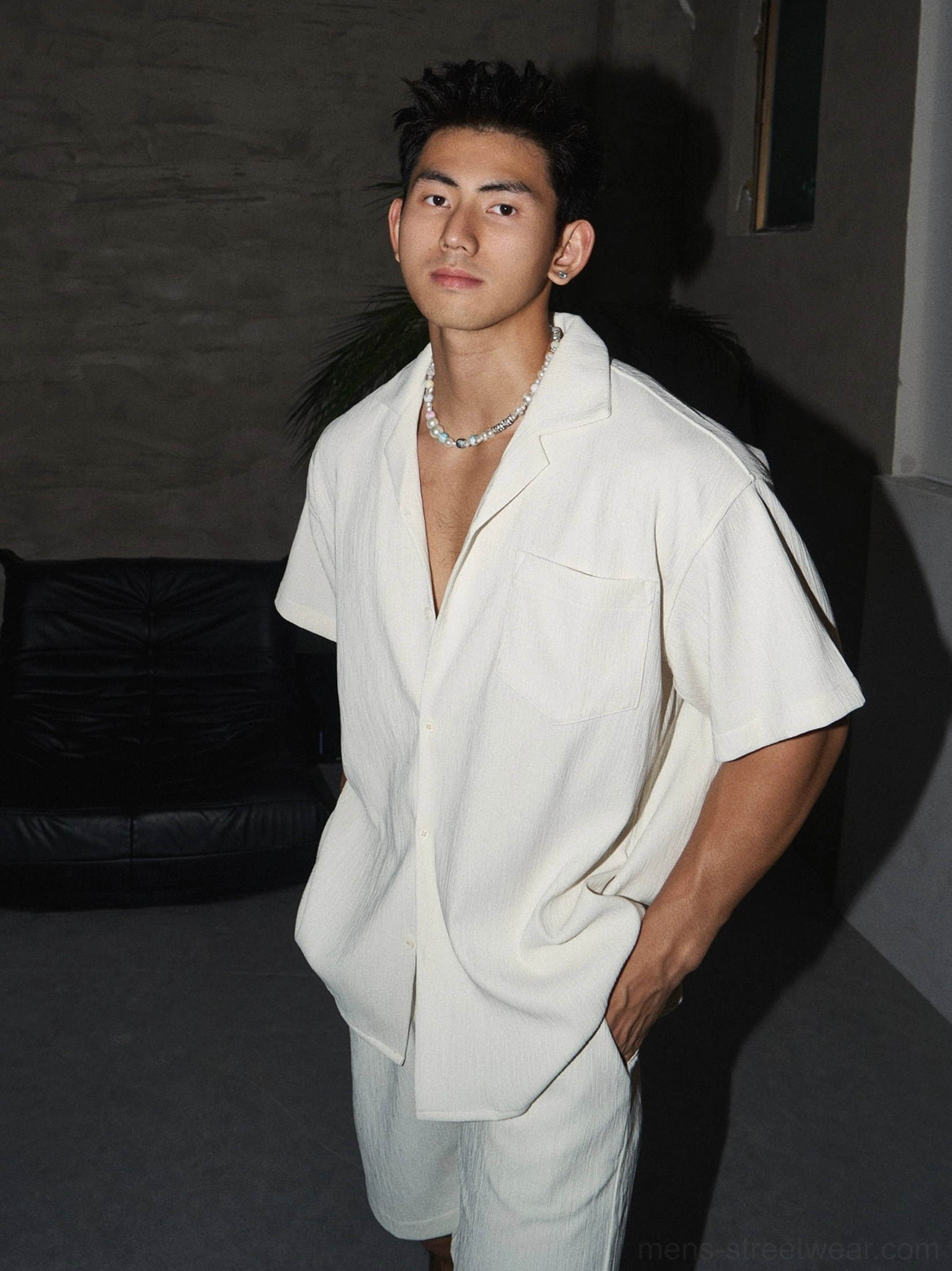 Men's off-white open camp collar shirt and matching shorts outfit styled with silver chain necklace