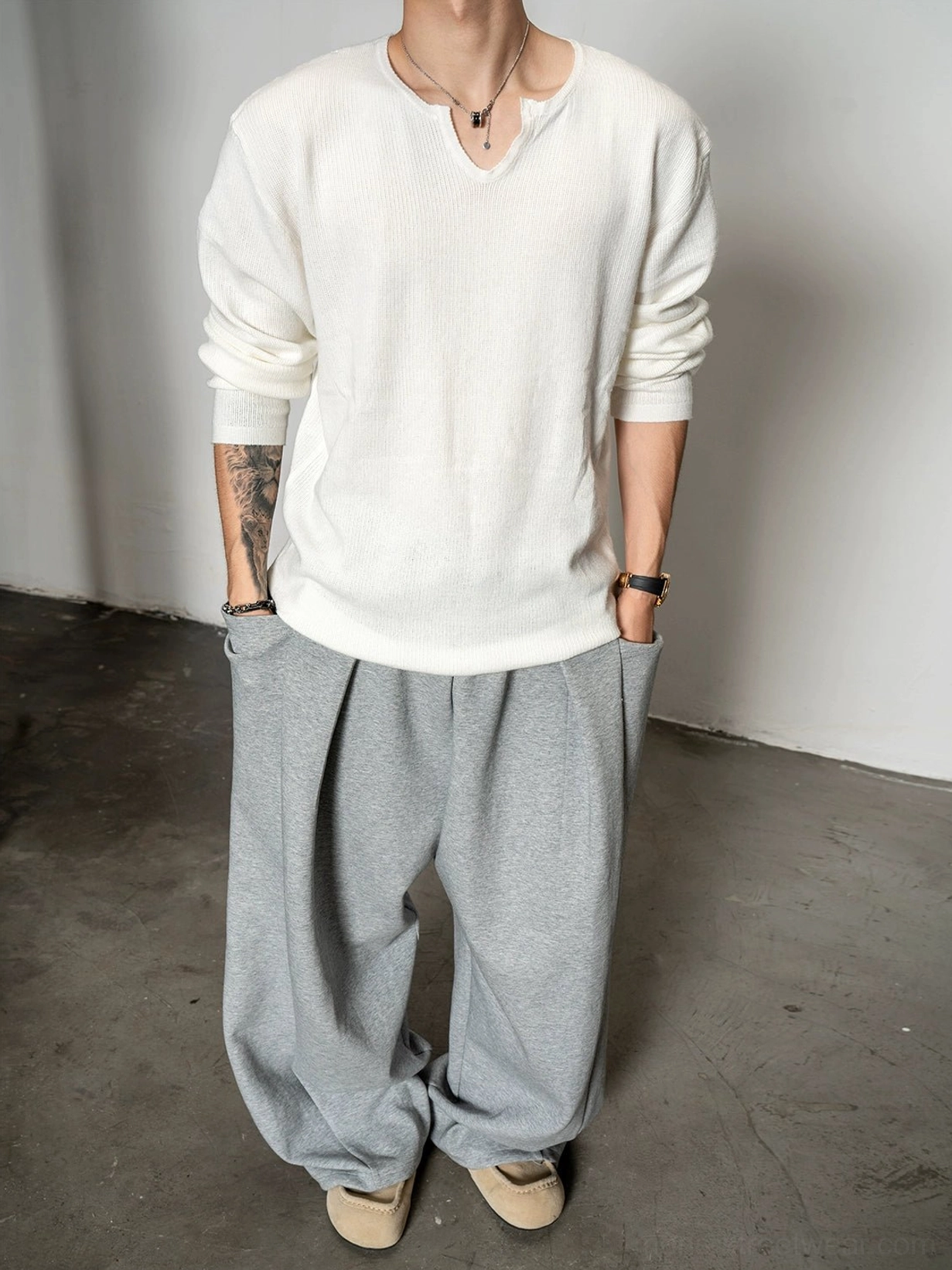 Off white relaxed notch neck knit sweater for men shown from the back with dropped shoulder silhouette