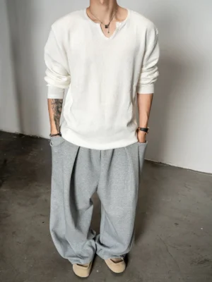 Off white men's relaxed notch neck knit sweater back view with dropped shoulders and gray oversized sweatpants