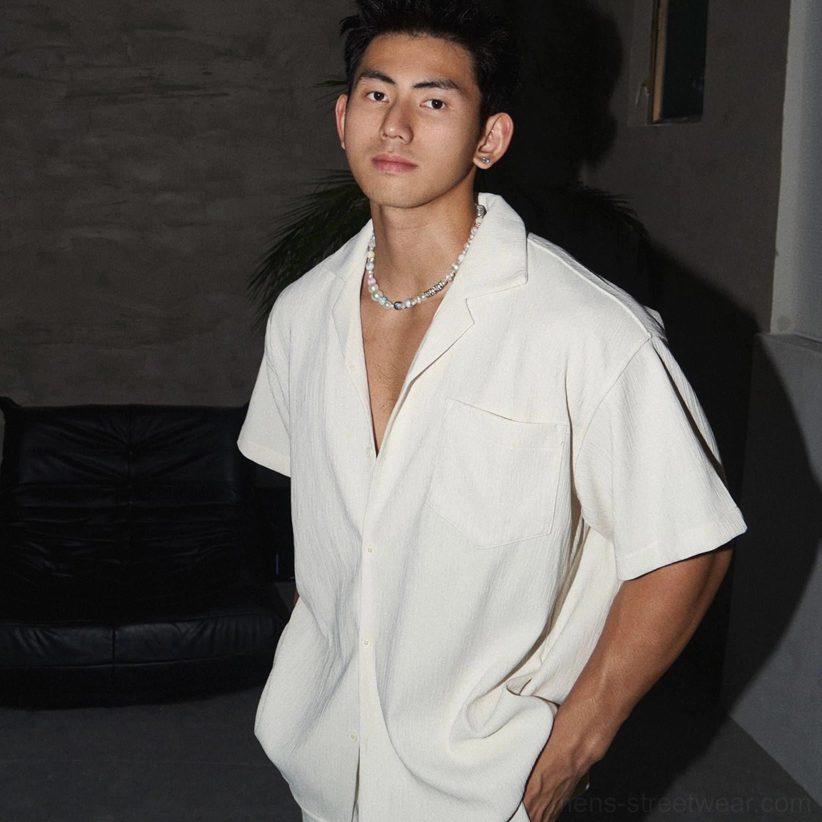 Close-up of men's off-white textured linen-look camp collar shirt with chest pocket and silver chain
