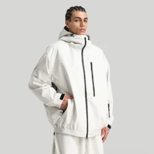 Men's off white waterproof techwear ski shell jacket with hood, black zipper and chest pocket worn in studio
