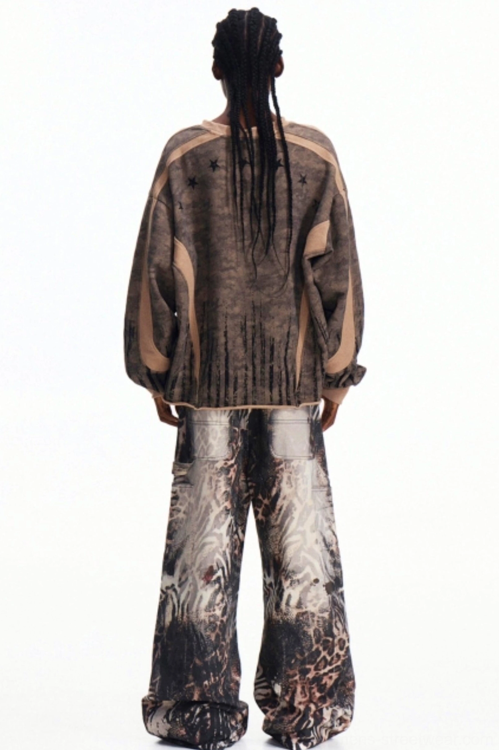 Men's oversized camouflage half-zip top shown from the back with ribbed trim and loose baggy streetwear trousers