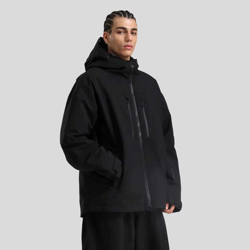 Minimal black men’s hooded snowboard jacket with full front zipper and zip pockets, styled with black pants
