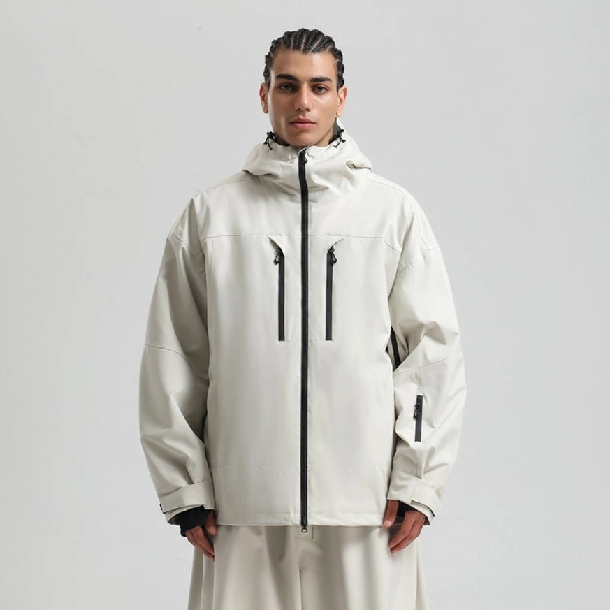 Off-white hooded outdoor jacket with black chest zippers, sleeve pocket, relaxed fit, and matching cream trousers