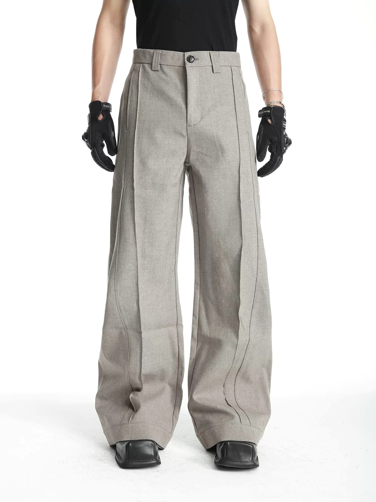 Men's heather gray pleated barrel-leg tailored trousers styled with black t-shirt gloves and square-toe shoes front full-body view