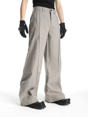 Men's relaxed wide-leg tailored trousers with front pleats and structured waistband shown in three-quarter front view