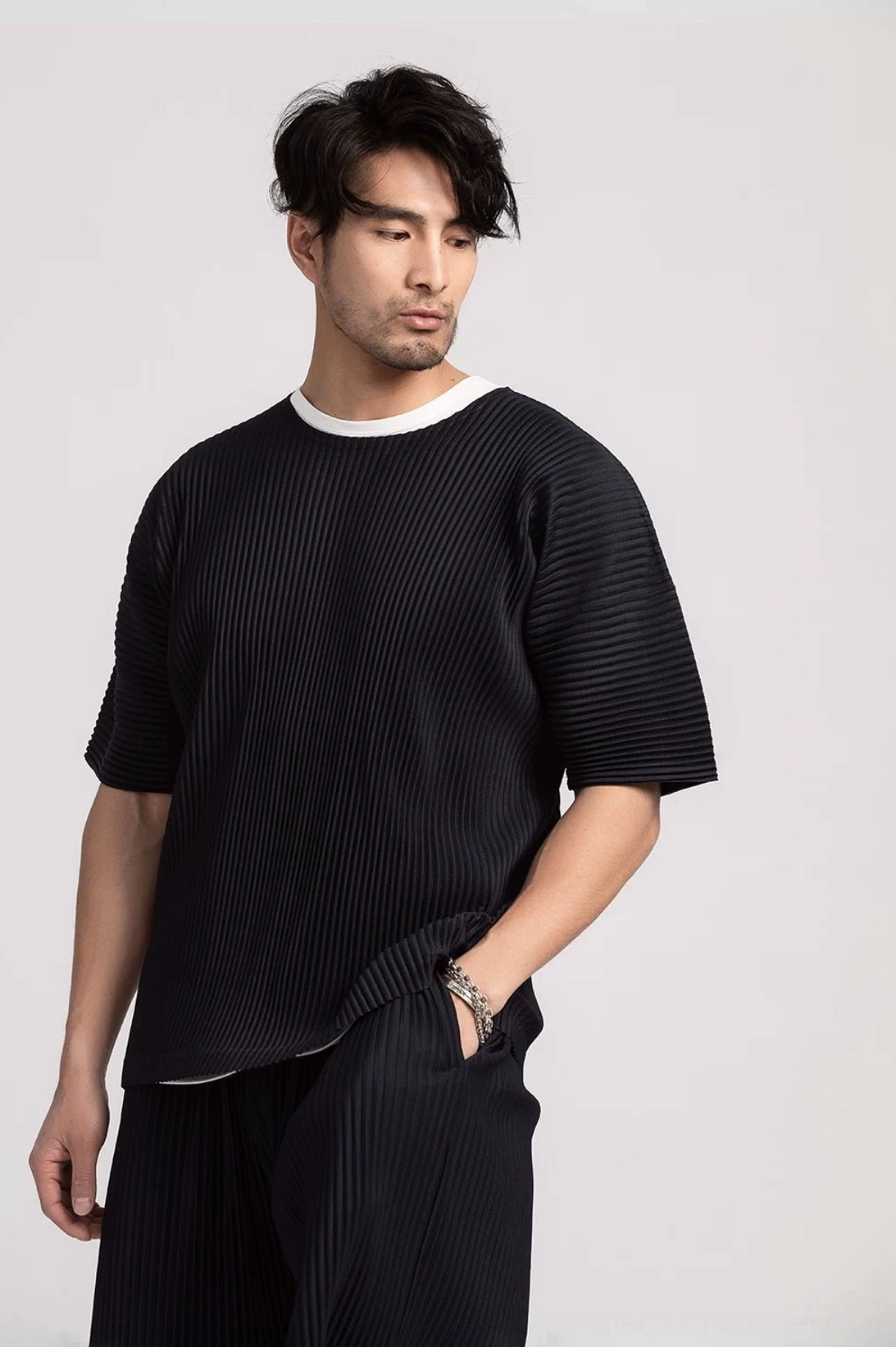 Men's pleated boxy tee front detail showing vertical ribbed texture and minimalist Korean streetwear design