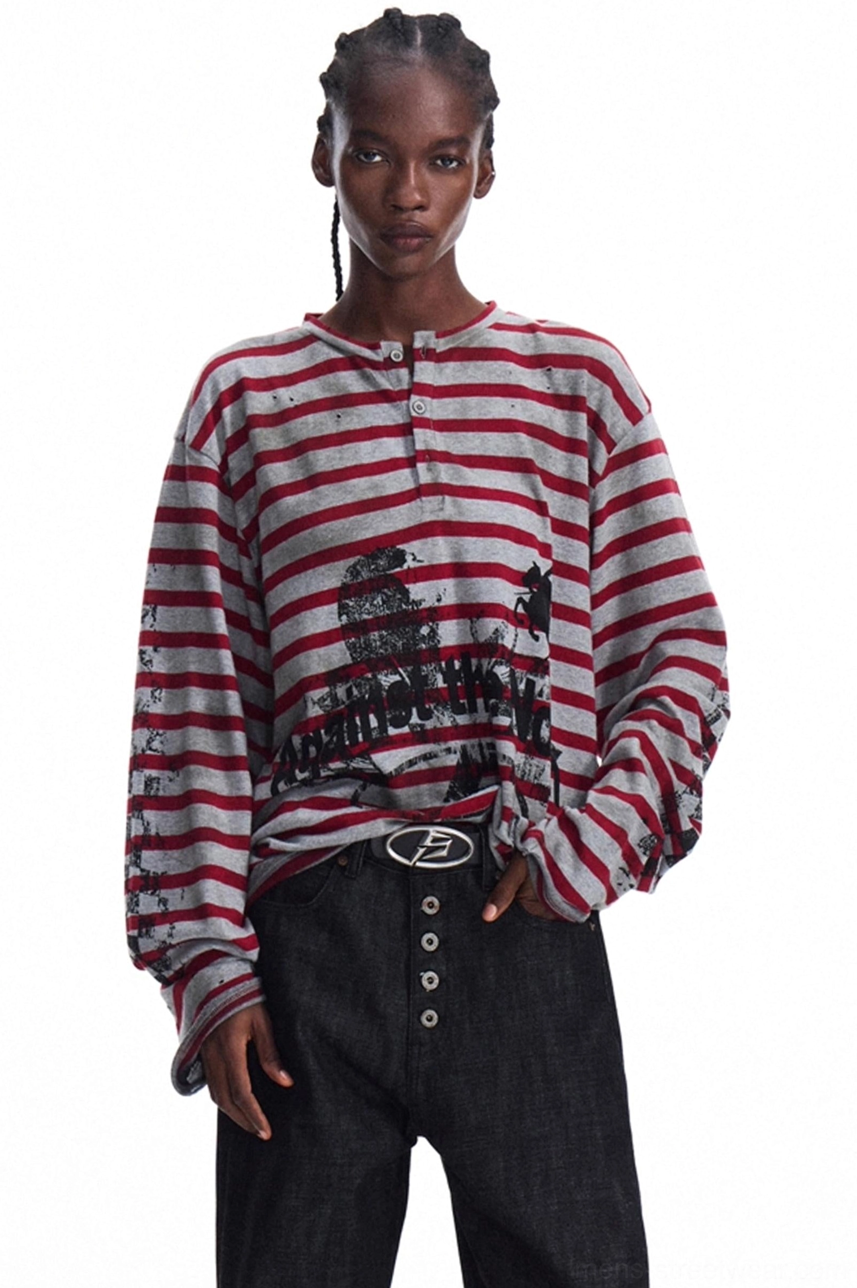 Men's red and grey striped graphic knit Henley long sleeve shown in front three-quarter view with black wide-leg jeans