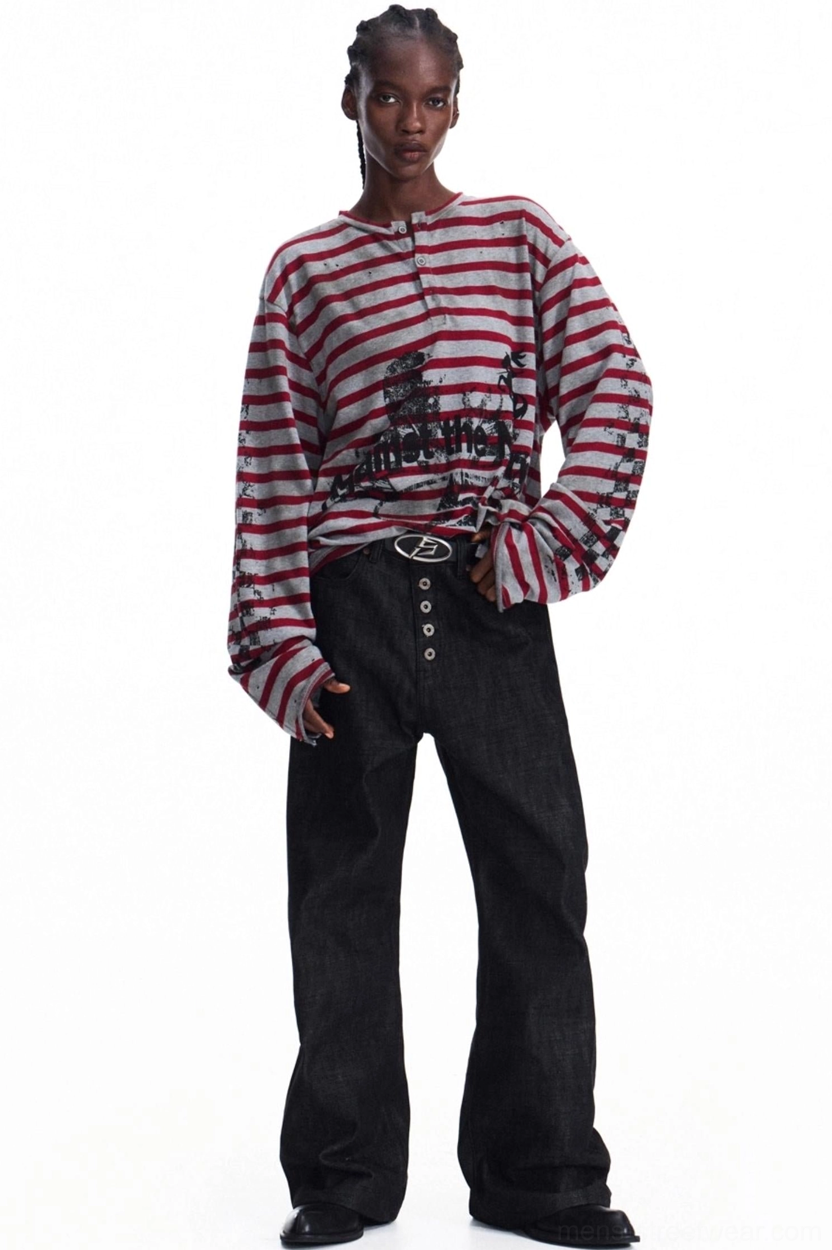 Full front outfit view of men's red grey striped graphic knit Henley styled with black wide-leg jeans