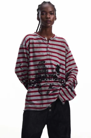 Front view of men's red striped graphic knit Henley top with half-button neckline and curved hem