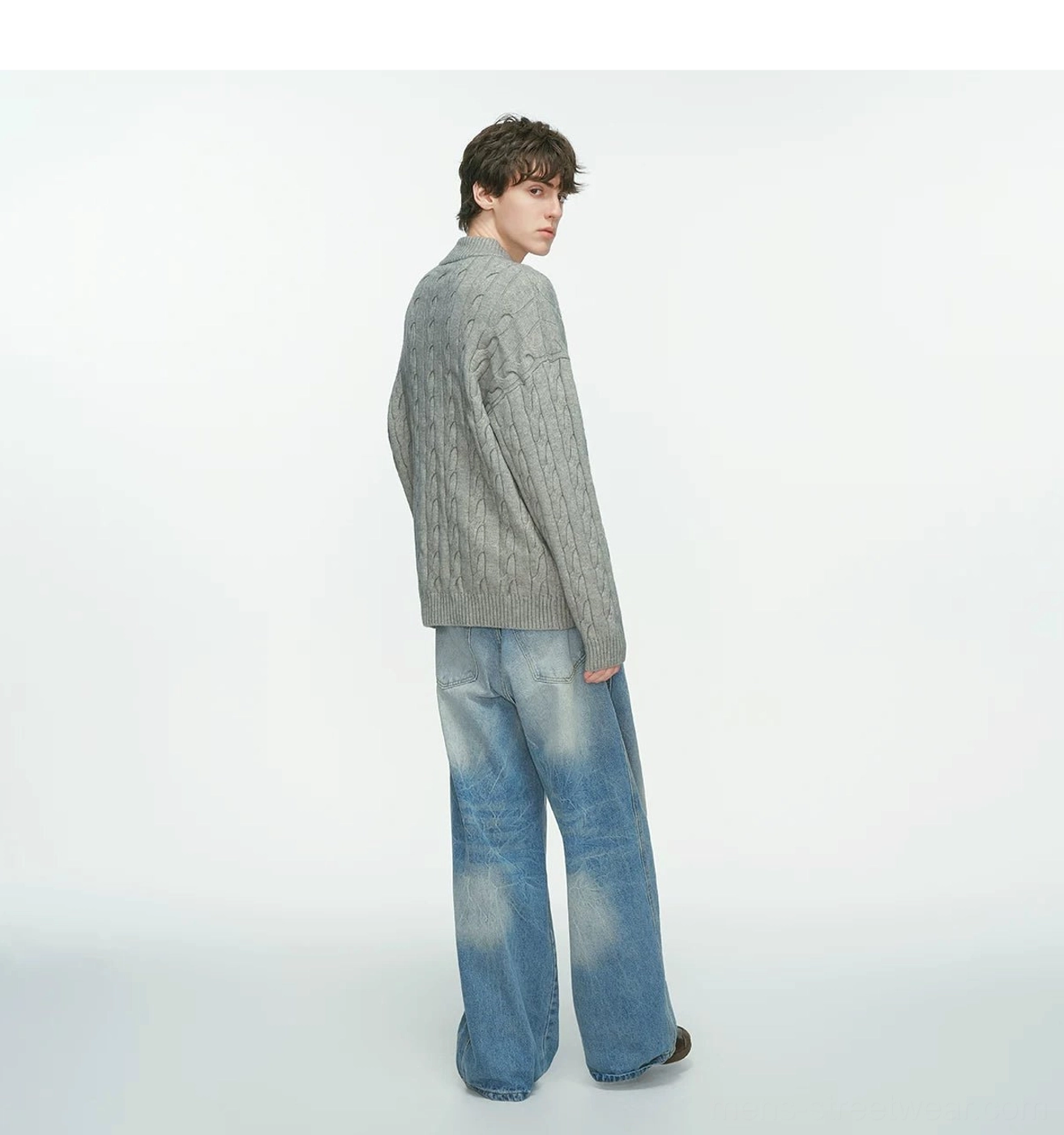 Men’s relaxed cable knit half-zip sweater showing its textured knit and stand collar