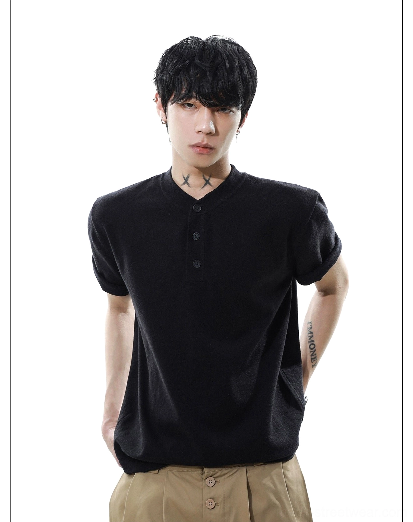Angled front view of black textured knit Henley T-shirt with curved hem and three-button collar