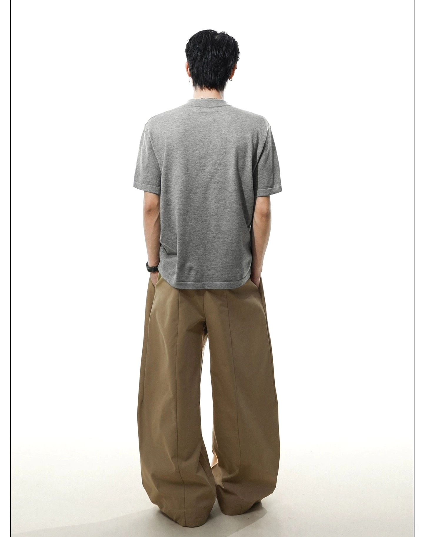 Back view of heather gray men's relaxed knit Henley T-shirt showing the clean rear panel and curved back hem