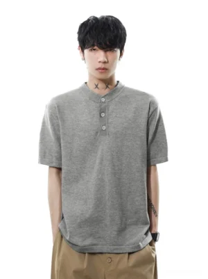 Heather gray men's relaxed knit Henley T-shirt with textured fabric, three-button collar, and curved hem front close-up