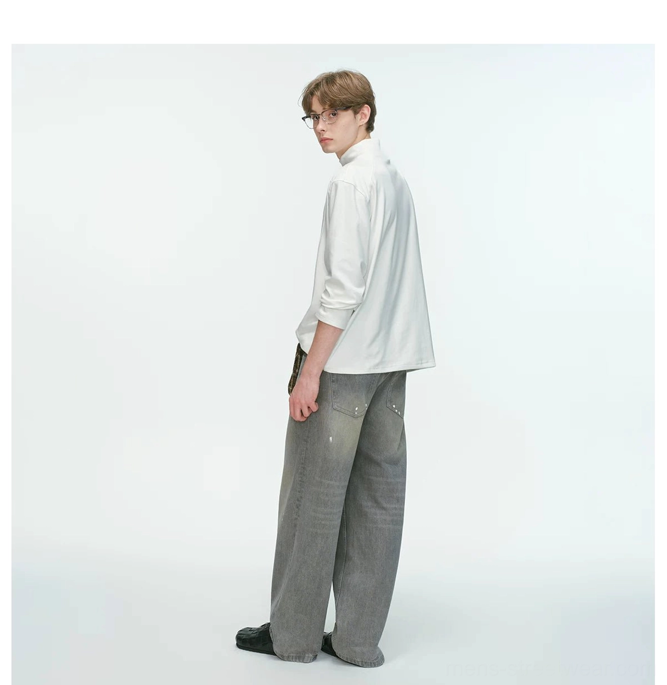 Men's relaxed mock neck long sleeve top highlighting the smooth fabric surface, dropped shoulders, and boxy streetwear fit