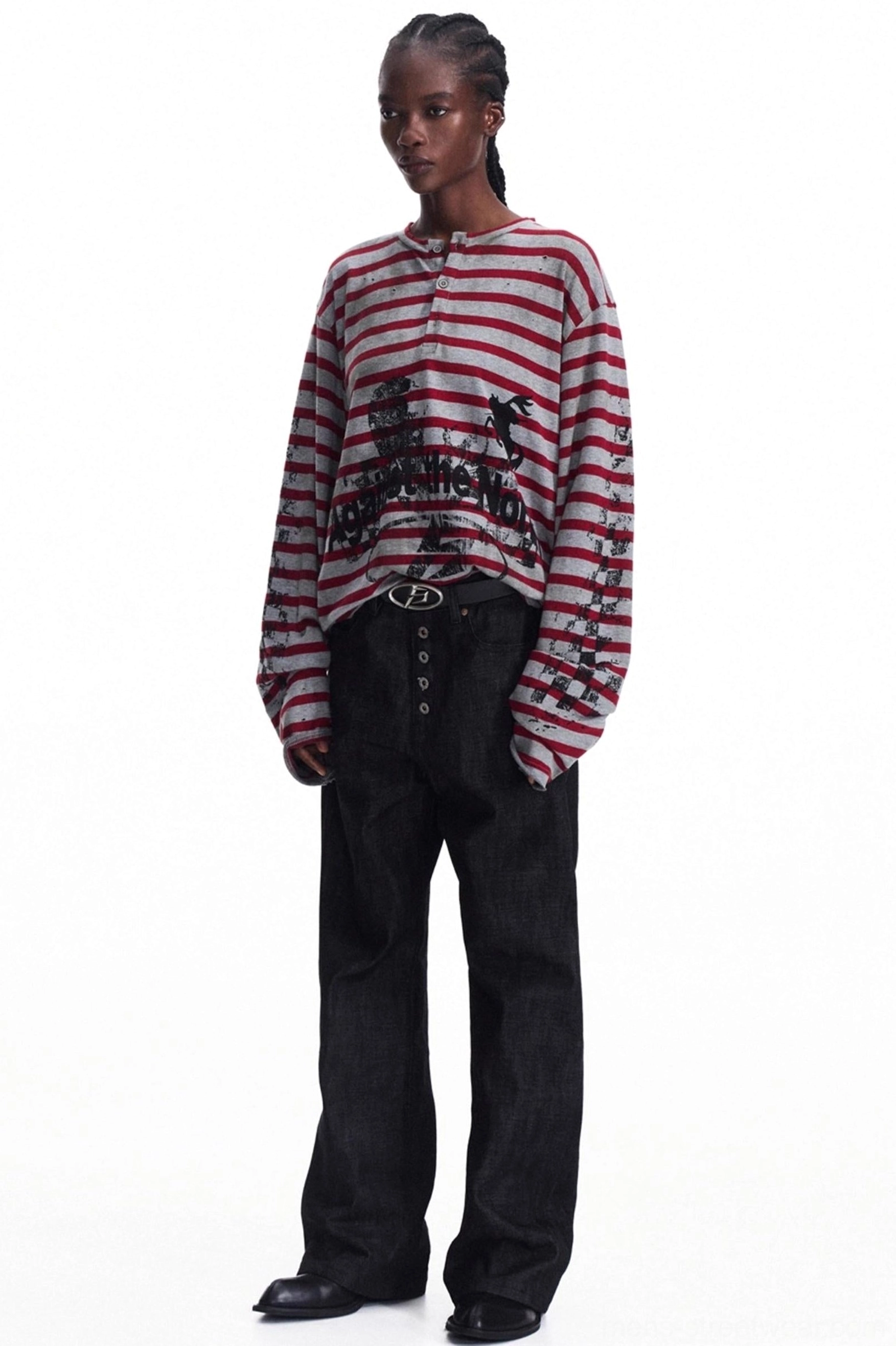 Relaxed fit men's red striped graphic knit Henley paired with black wide-leg denim in full body view
