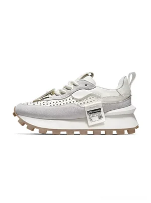 Side view of men's retro layered leather running sneakers with grey and off-white panels, perforated toe box, chunky stacked midsole, and tan rubber outsole